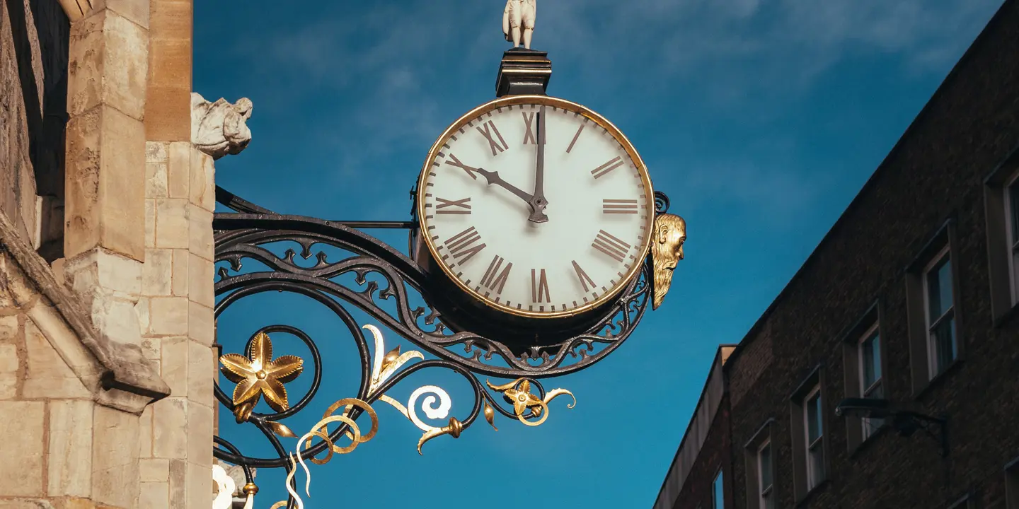 A clock attached to the side of a building.