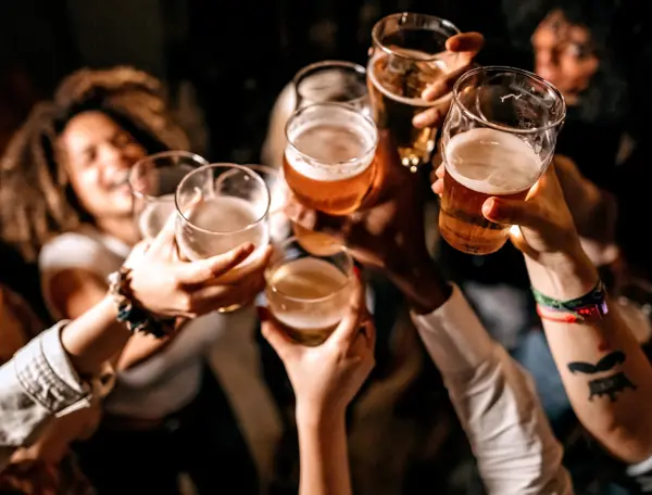 A group of individuals raising beer glasses.