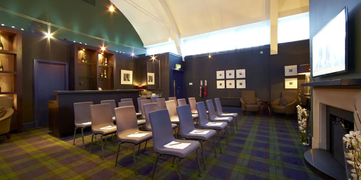 A room featuring chairs and a fireplace.