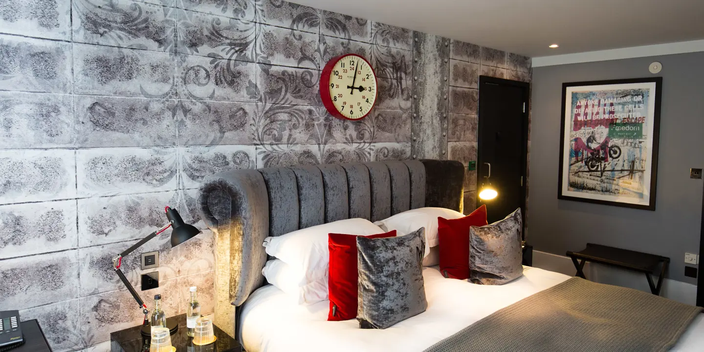 Bedroom featuring a comfortable bed and a wall-mounted clock.