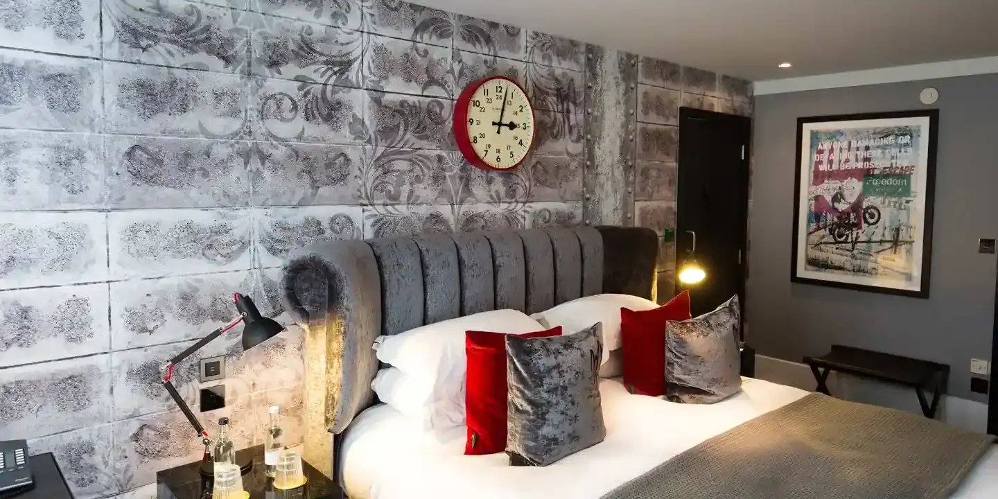 Bedroom featuring a comfortable bed and a wall-mounted clock.