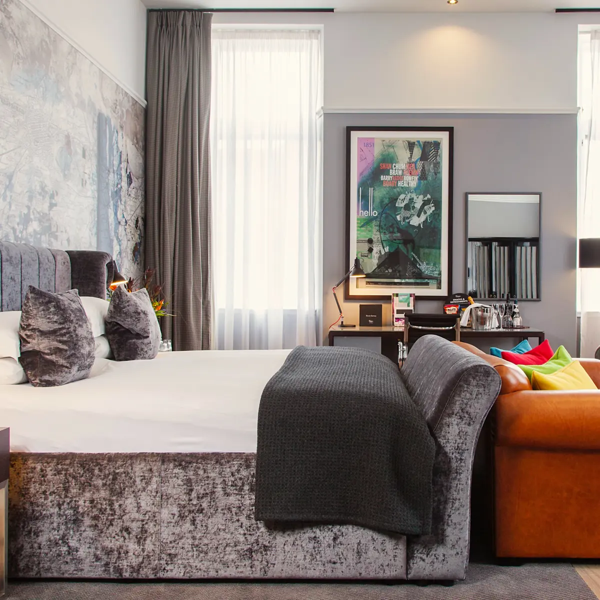 Spacious bedroom featuring a king-sized bed and an elegant chair.