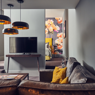 A well-furnished living room featuring a flat-screen TV.