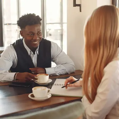 Man and woman having coffee and talking