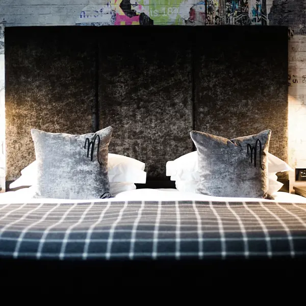 Bed with two pillows on top.
