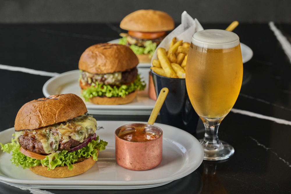 Cheeseburger served with fries and a pint of beer.