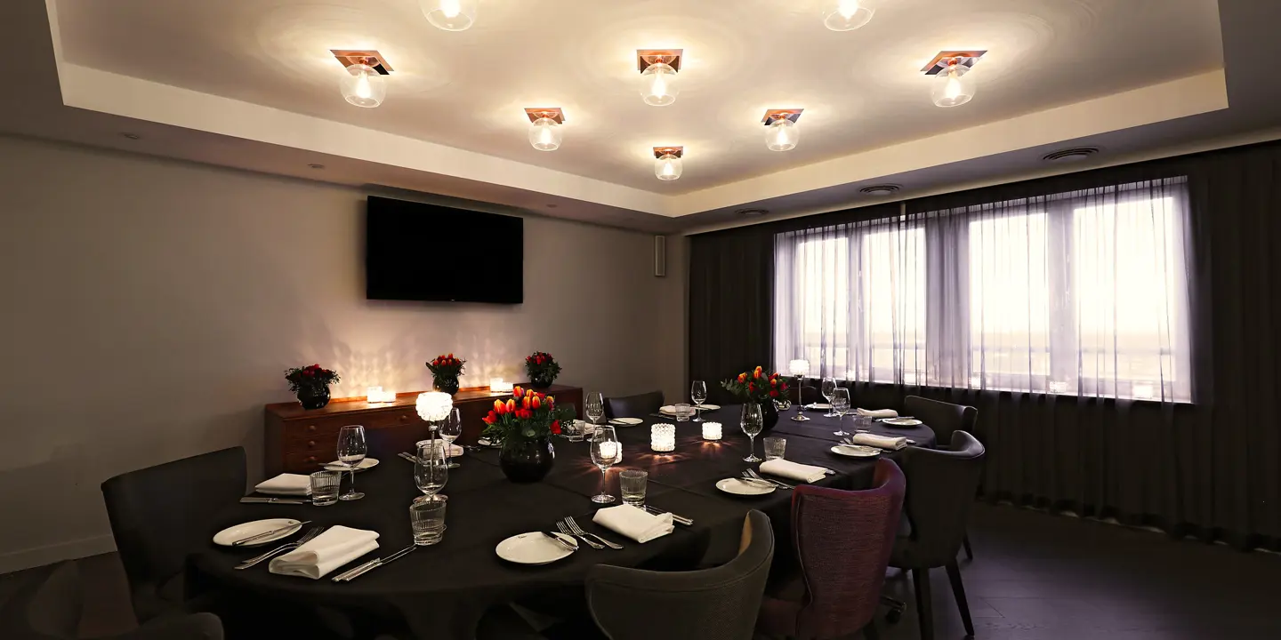 Dining room featuring a table and chairs with round glass ceiling lighting fixtures and a feature window 