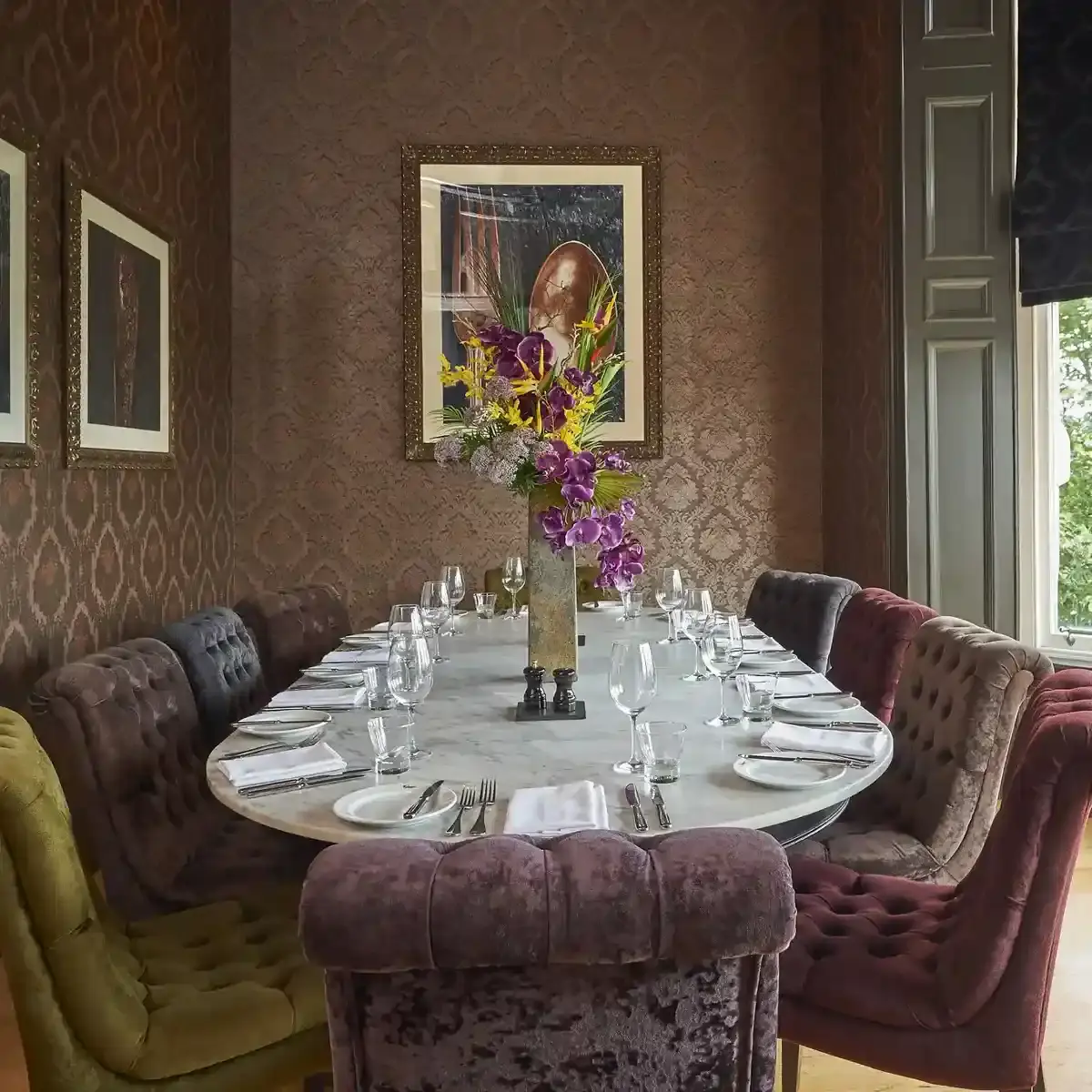 Dining room table adorned with a tastefully arranged vase of flowers.