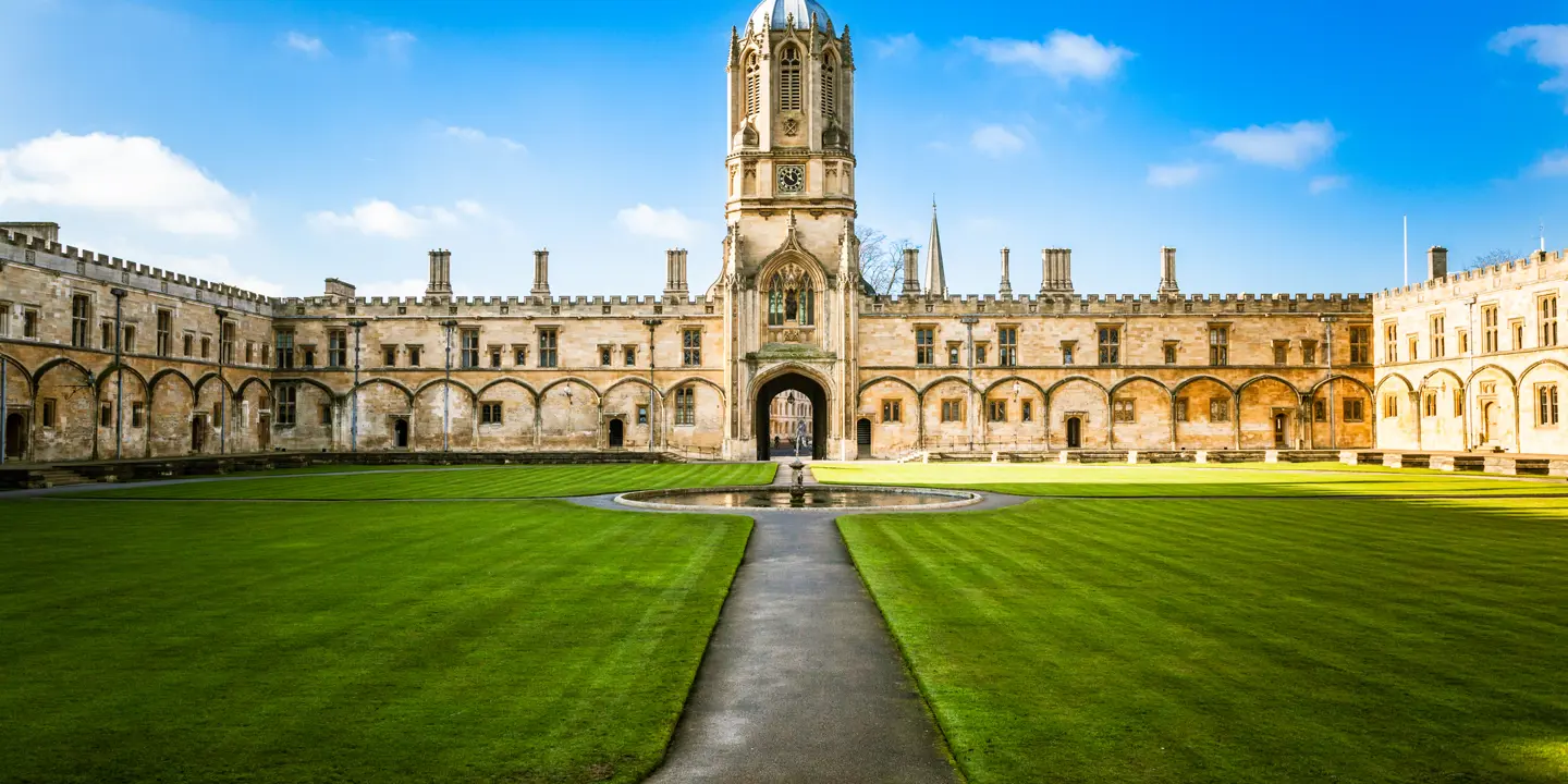 An imposing building featuring a clock tower atop.