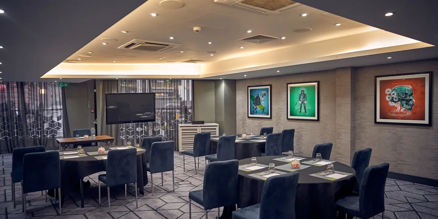 A spacious room adorned with tables, chairs, and wall art.