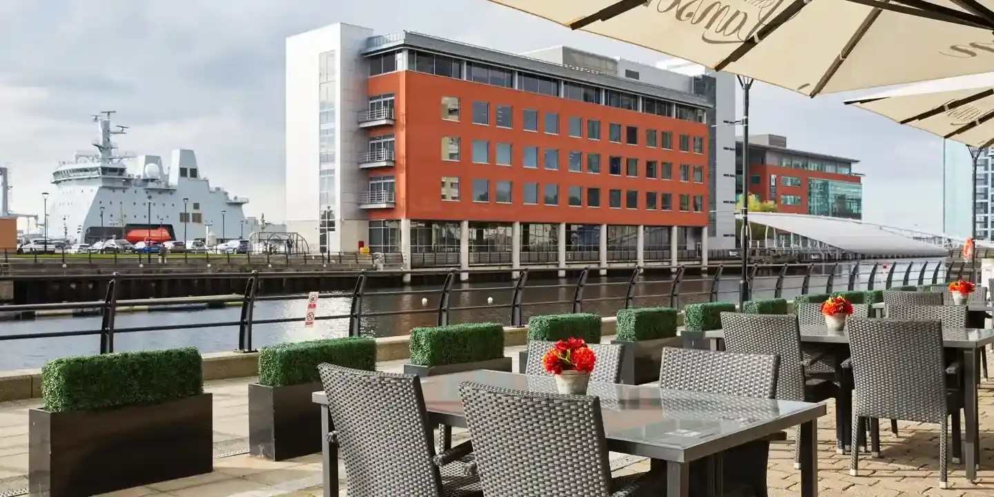 Outdoor dining area featuring tables, chairs, and umbrellas.