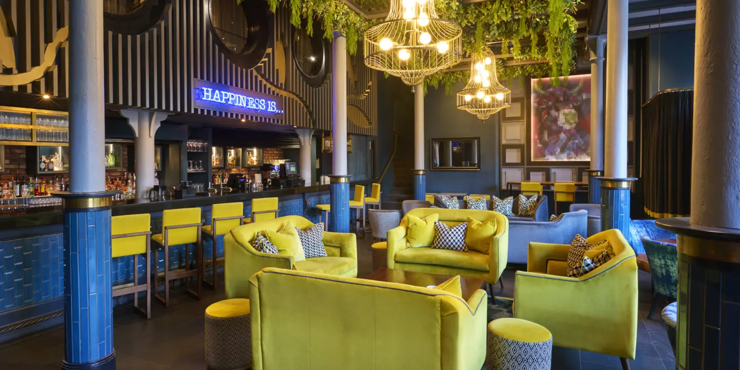 An eatery featuring yellow chairs and blue walls.