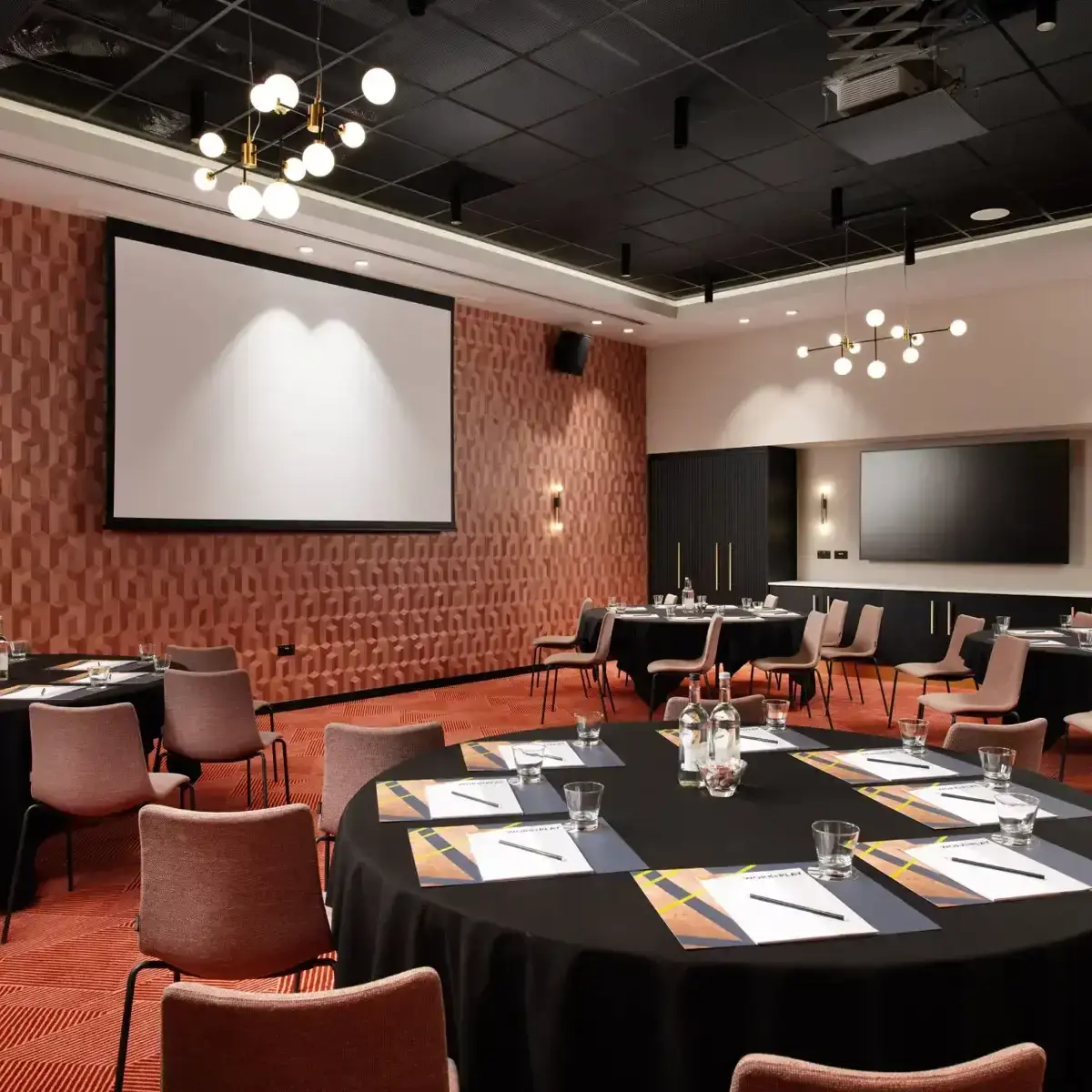 Conference room with projector screen and chairs.