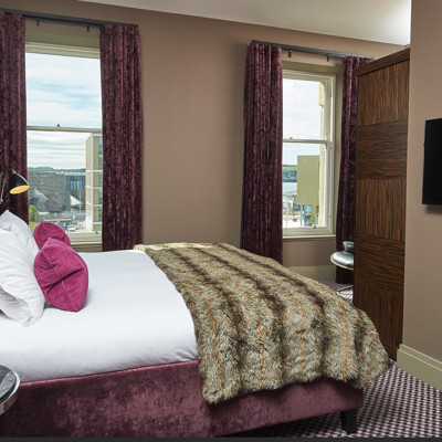 Spacious bedroom featuring a king-sized bed and a sleek flat-screen television.