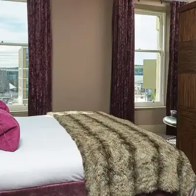 Spacious bedroom featuring a king-sized bed and a sleek flat-screen television.