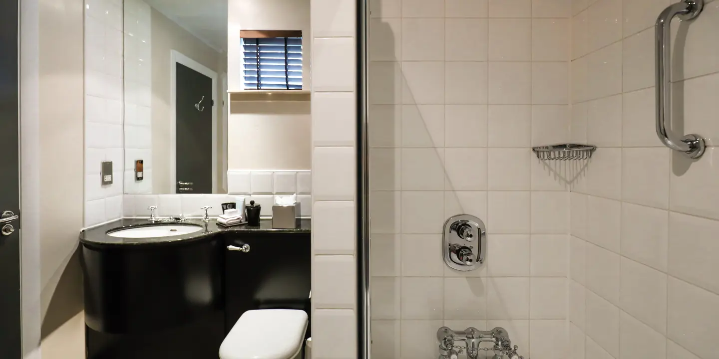 White toilet next to bathtub.