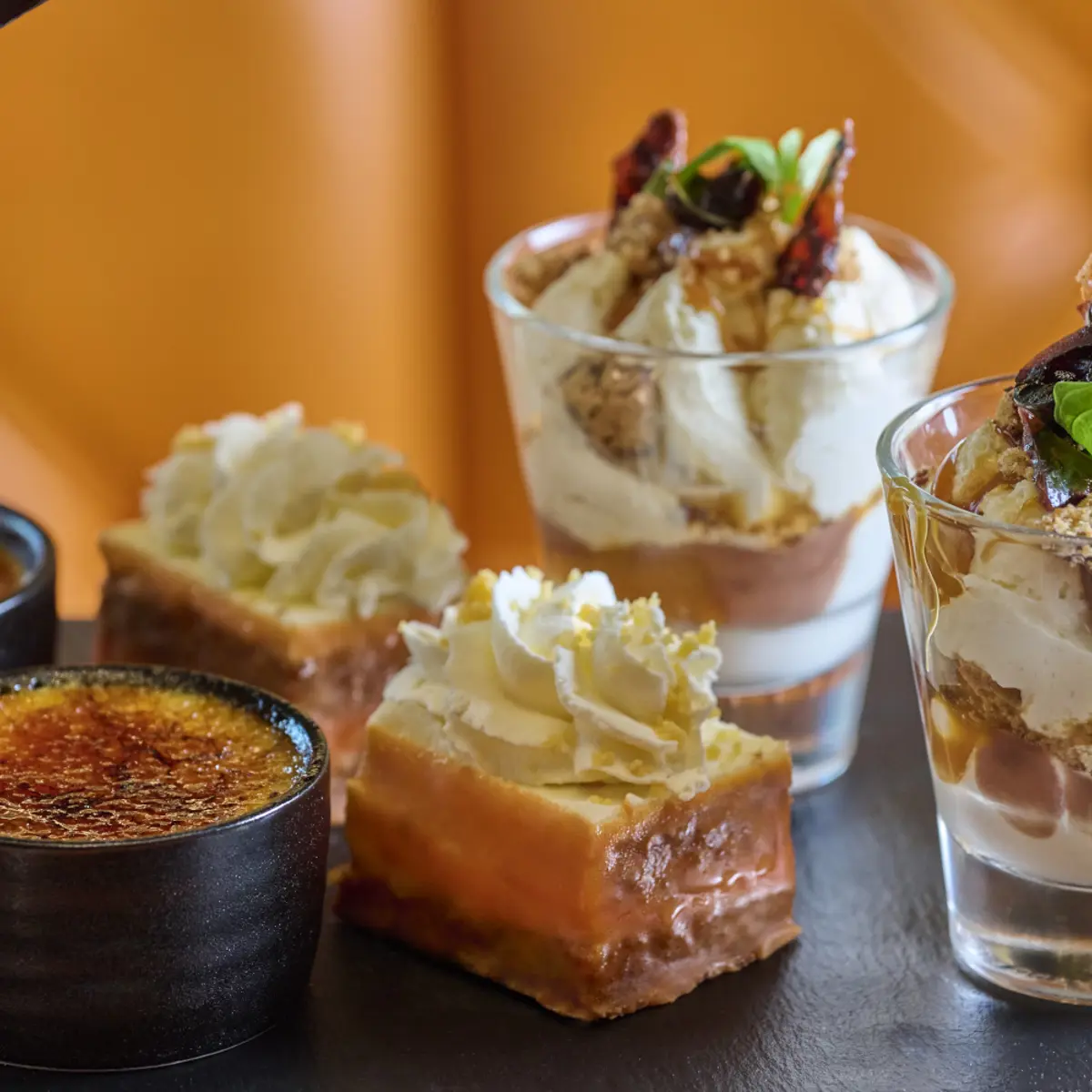 Assortment of pastries and desserts displayed on a table.