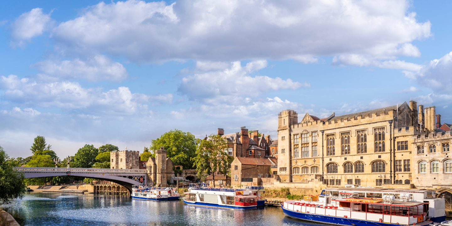 Several boats peacefully floating on a serene river.