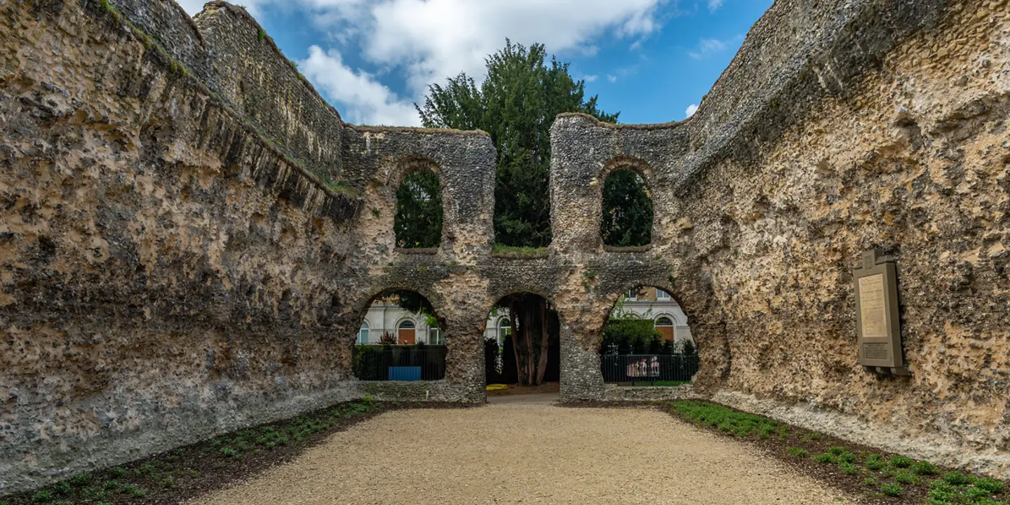 An impressive stone building featuring elegant arched windows.