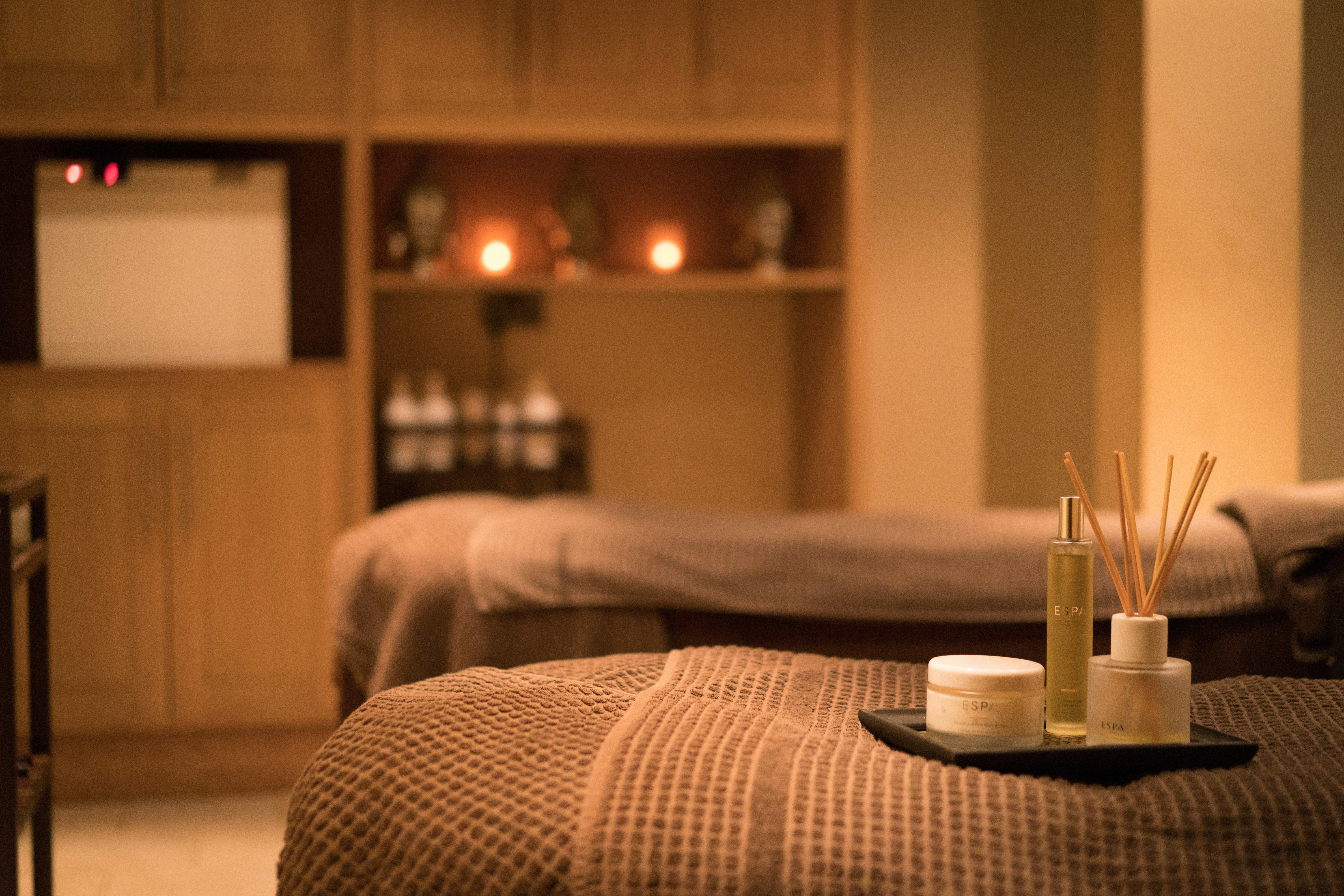 Skin care products and diffuser on a massage bed