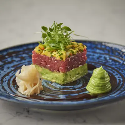 Plate of colourfully stacked food.