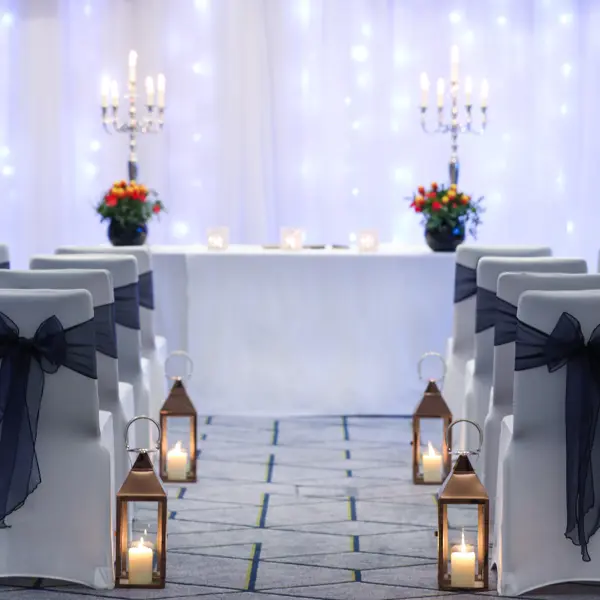 Chairs adorned with black and white sashes.