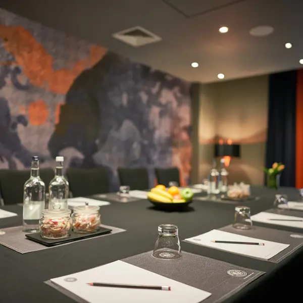 A table arranged with place settings for a meeting.