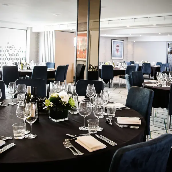 A table arranged with neatly set place settings.