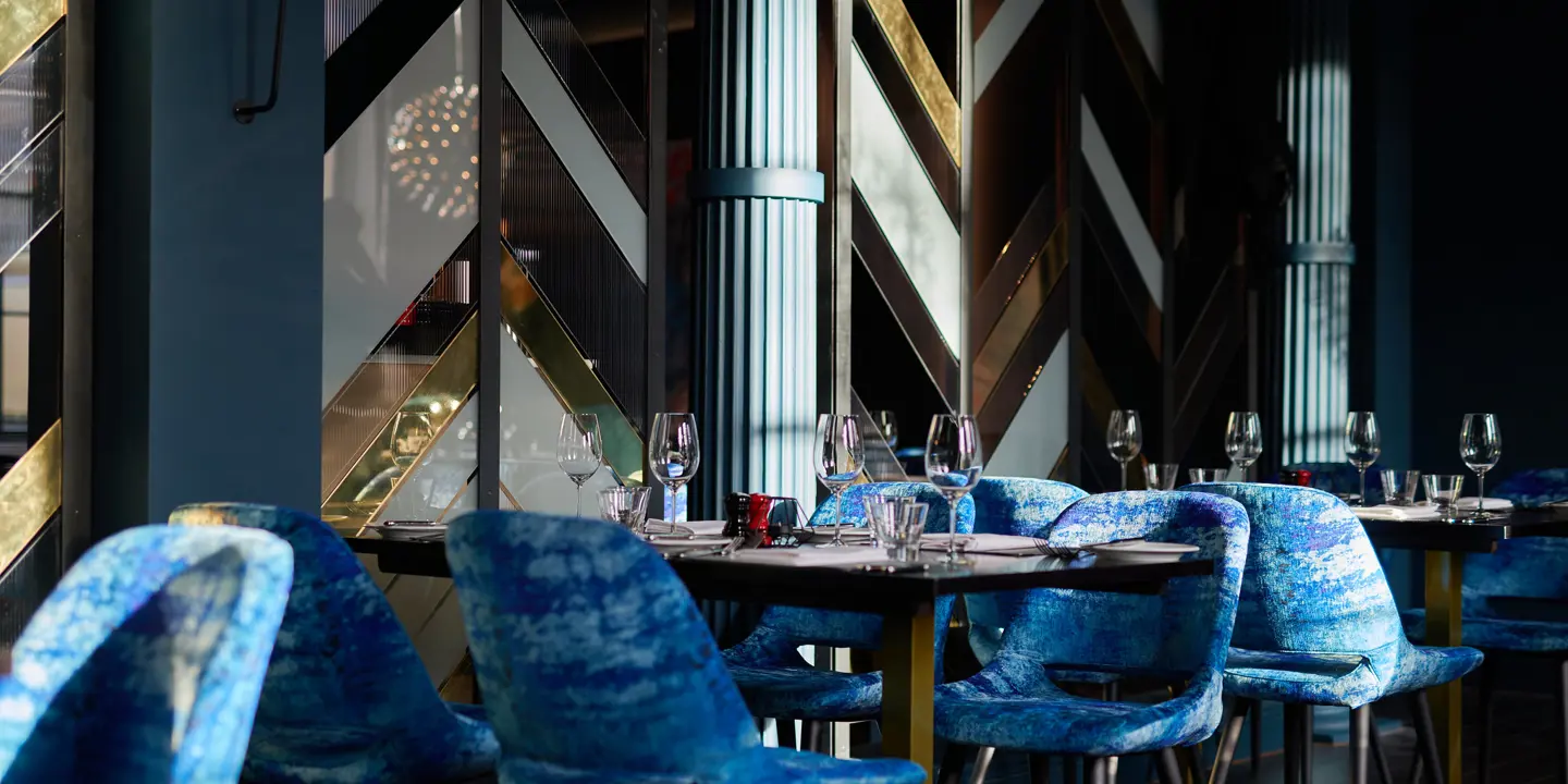 Dining room featuring elegant blue chairs and tables.