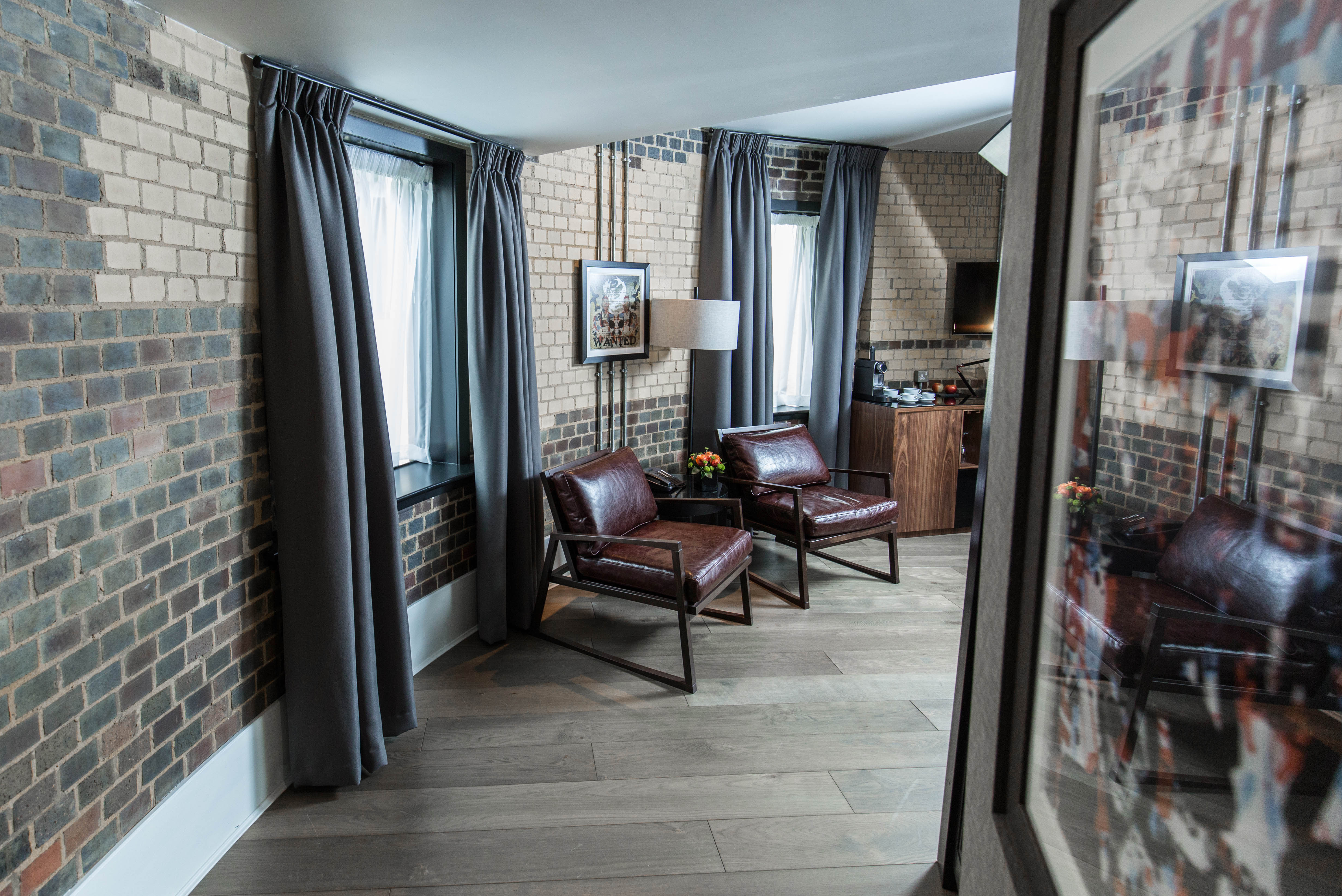 Two chairs and a table in a well-furnished living room.