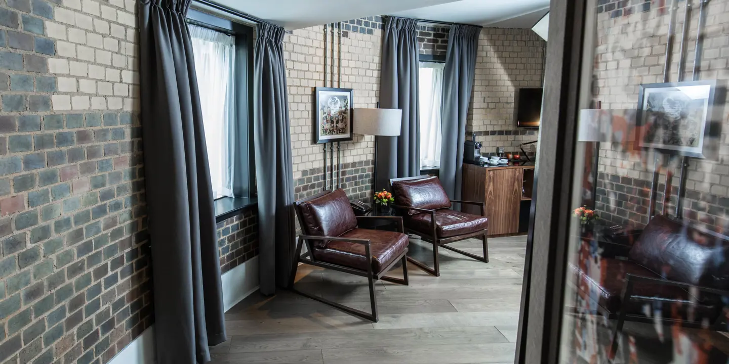 Two chairs and a table in a well-furnished living room.