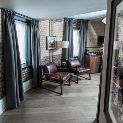 Two chairs and a table in a well-furnished living room.