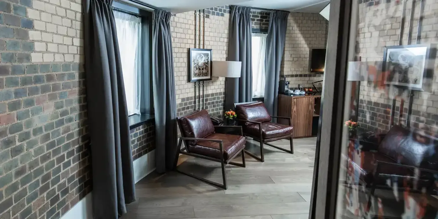 Two chairs and a table in a well-furnished living room.