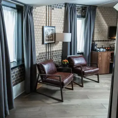 Two chairs and a table in a well-furnished living room.