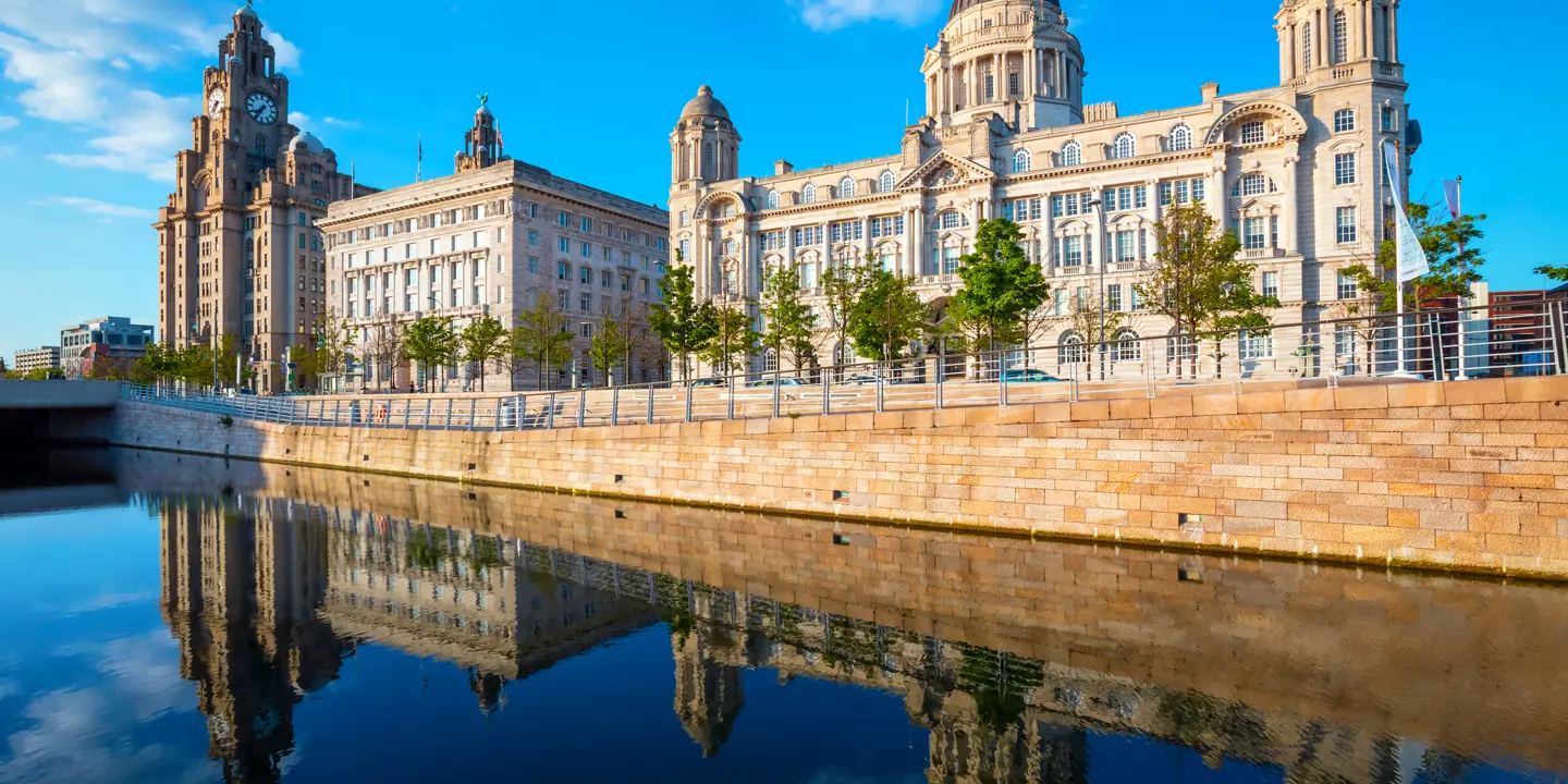 A spacious building situated alongside a serene body of water.