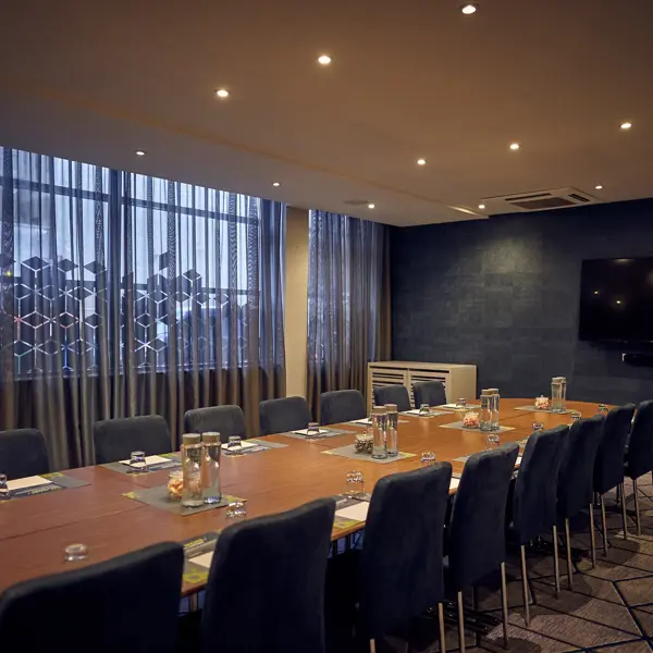 Conference room featuring a spacious table and chairs.