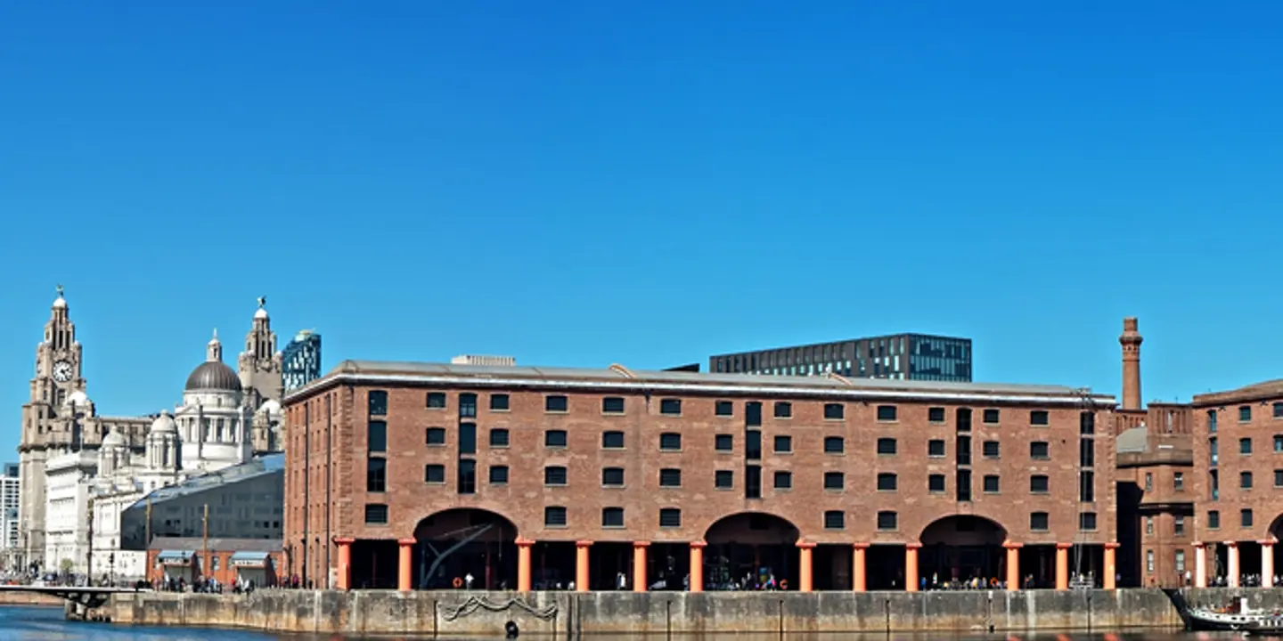 A spacious building situated alongside a serene body of water.