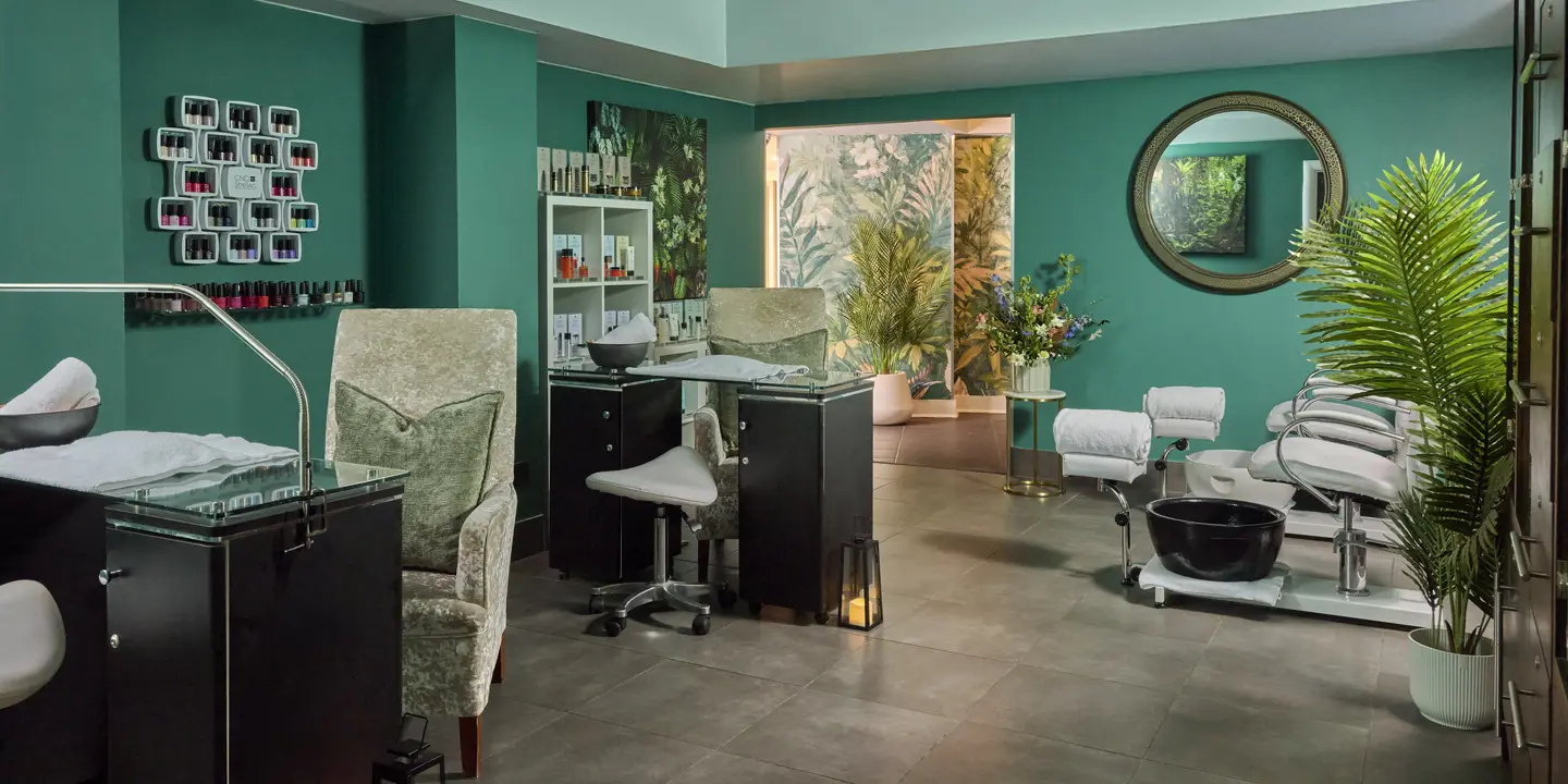 nail salon room with desk and chairs 