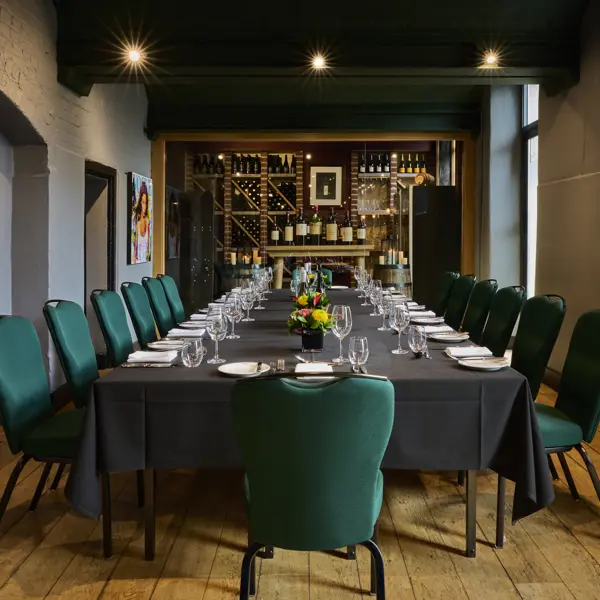A dining room featuring a lengthy table adorned with blue chairs.