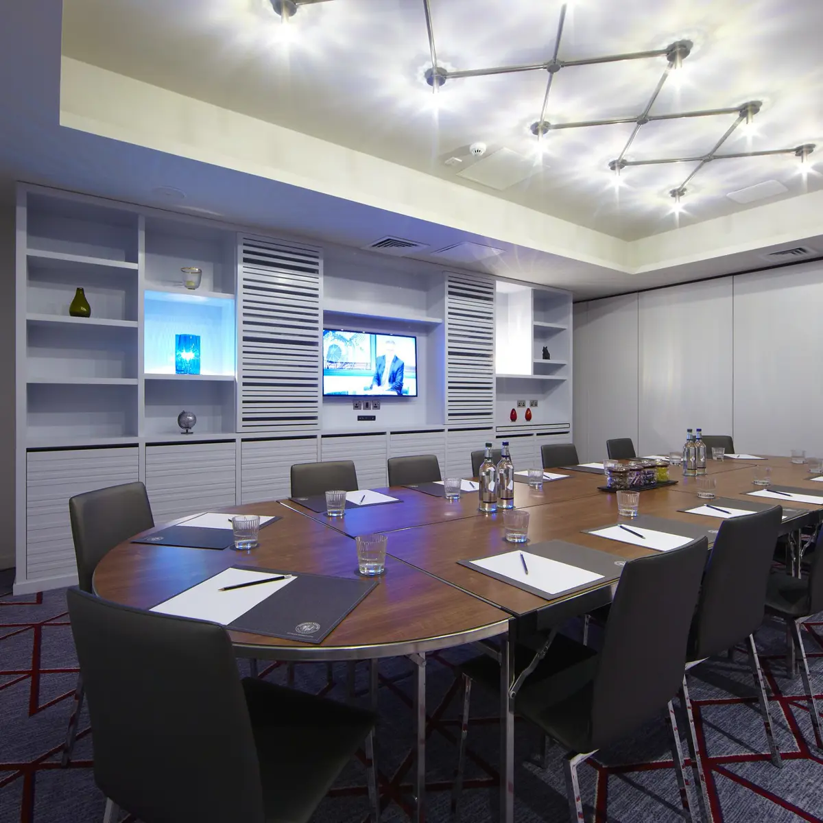 Conference room featuring a spacious table and chairs.