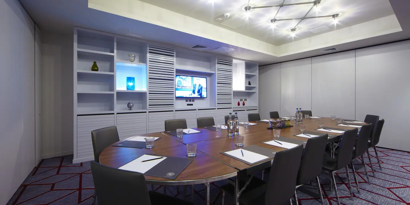 Conference room featuring a spacious table and chairs.