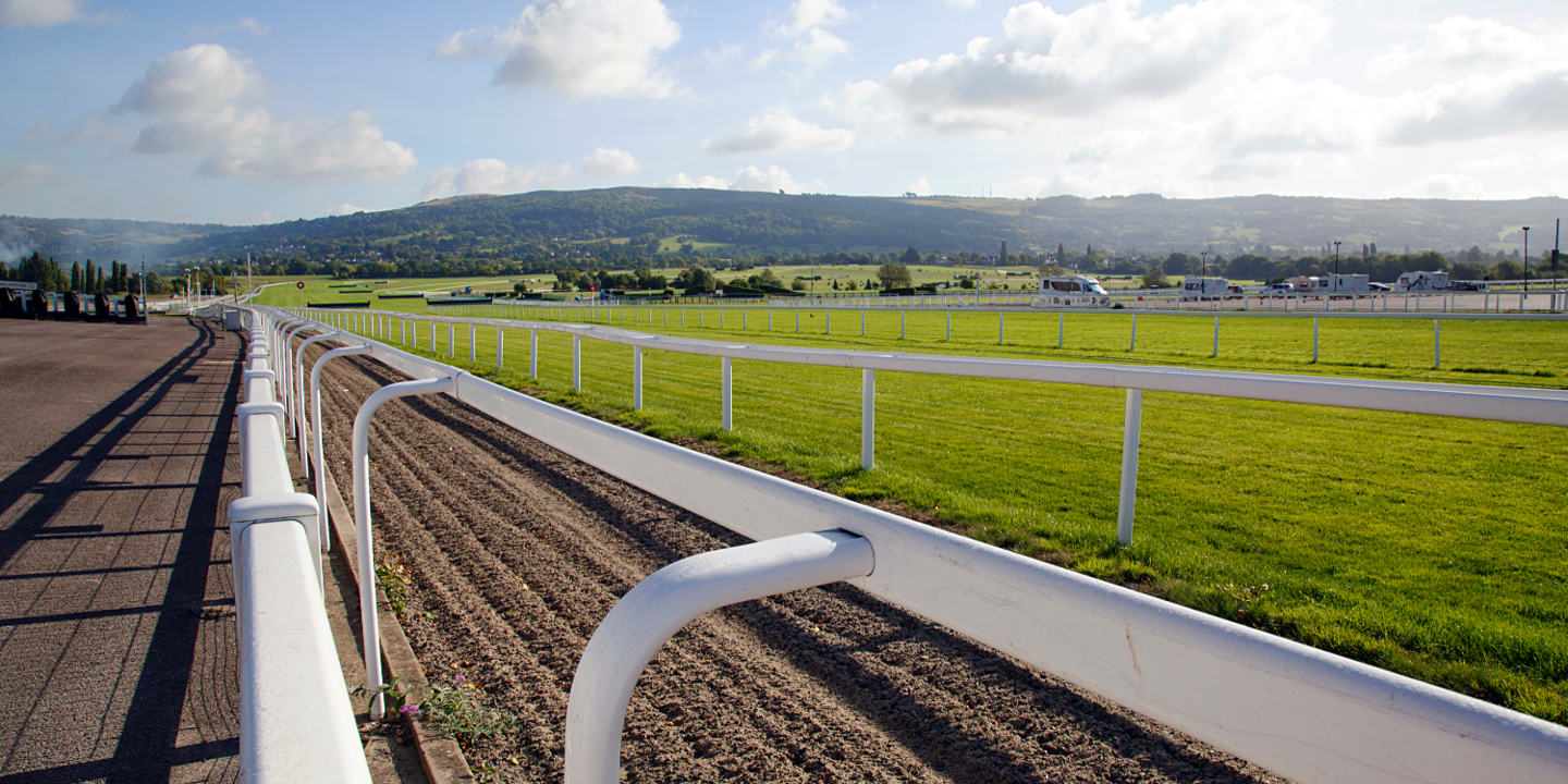 Side view of a horse race track, seen from the fence.