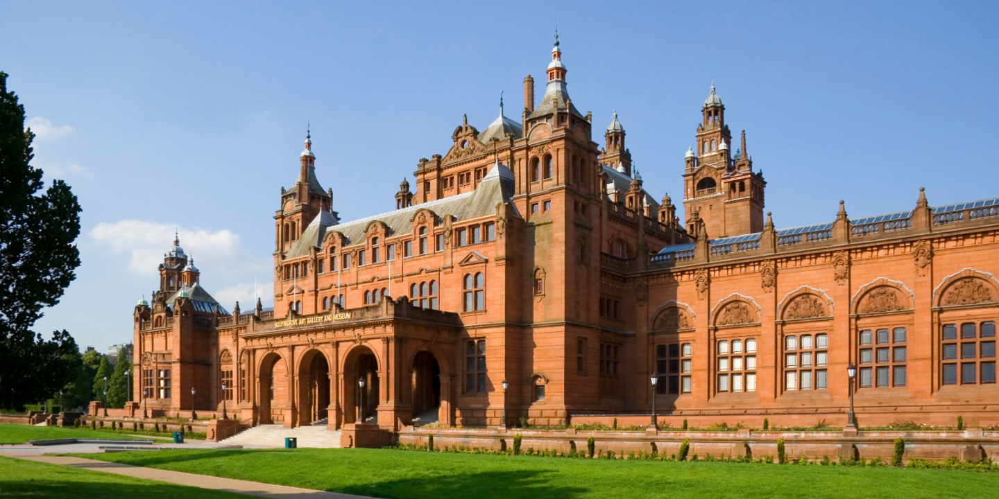 An imposing brick building featuring a prominent clock tower.