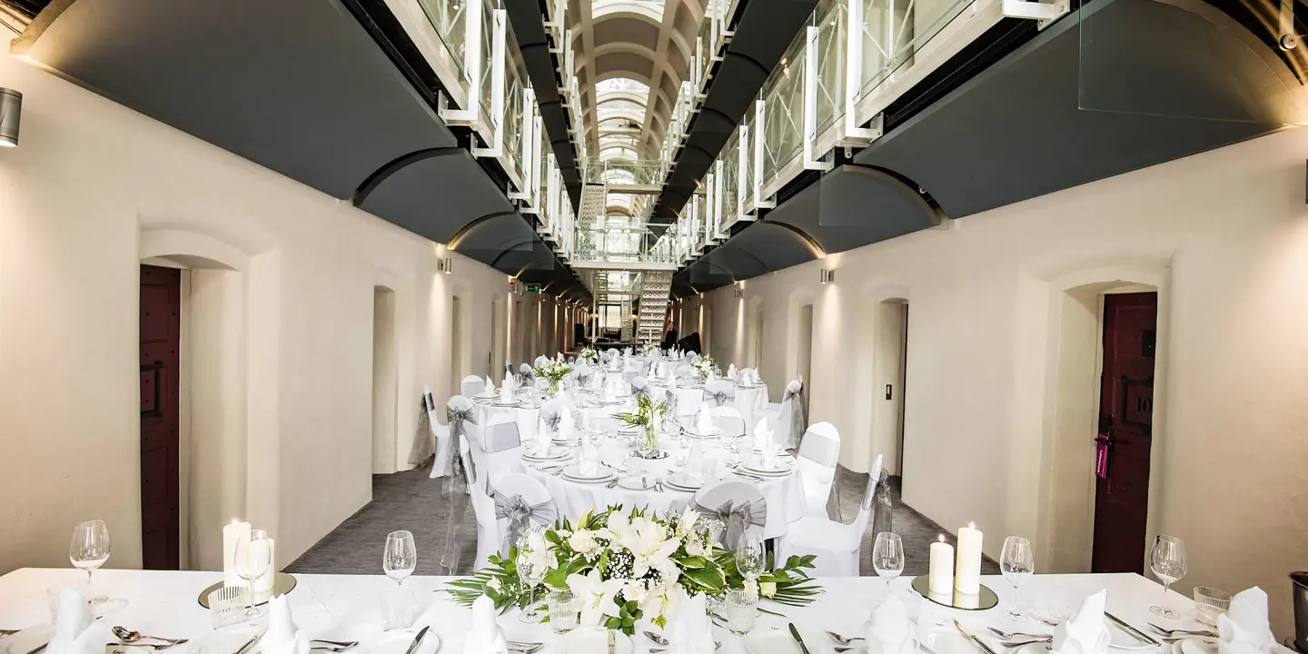 A table adorned with pristine white linens and elegantly arranged place settings.