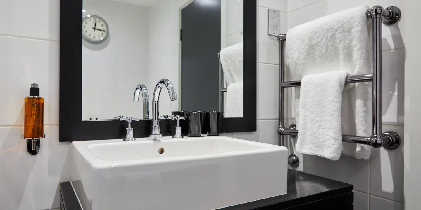 White sink positioned beneath a mirror in a bathroom.