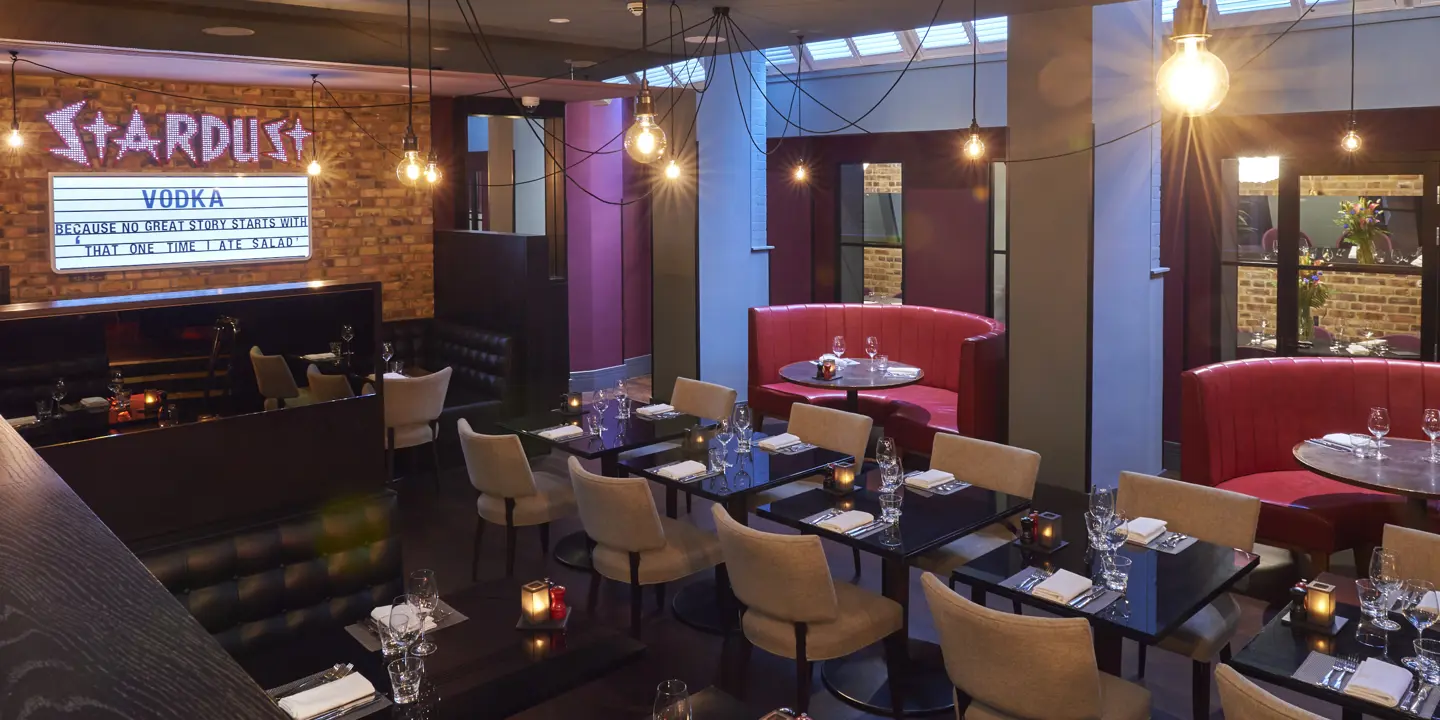 A spacious dining room filled with numerous tables and chairs.