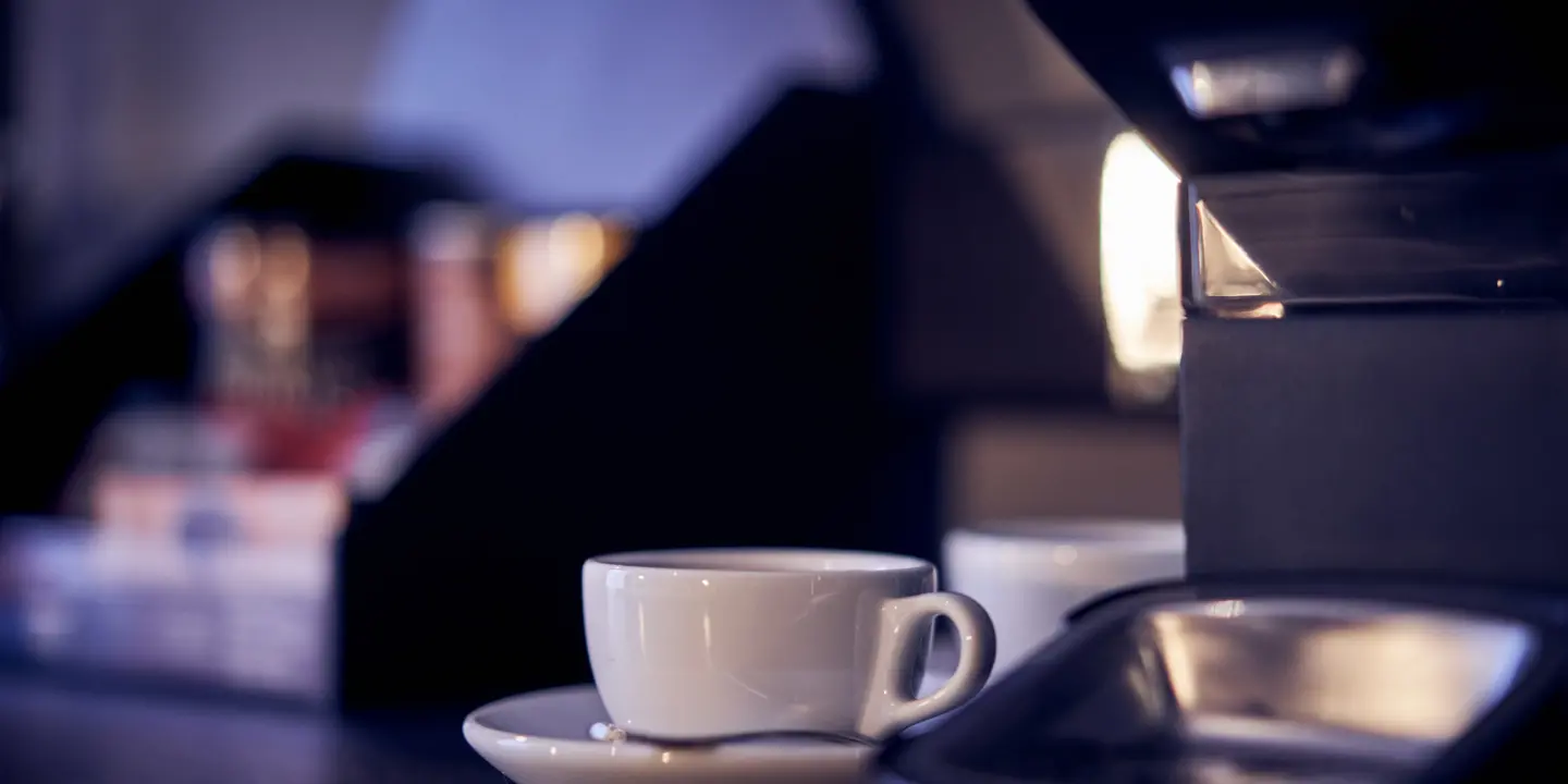 A coffee cup and saucer resting on a table.