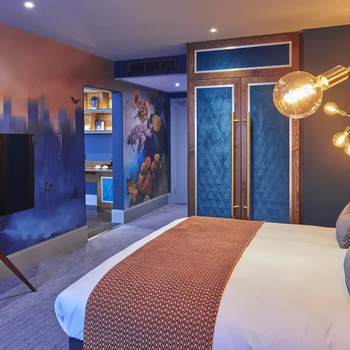 Neatly arranged bedroom with a well-made bed and a flat-screen TV.