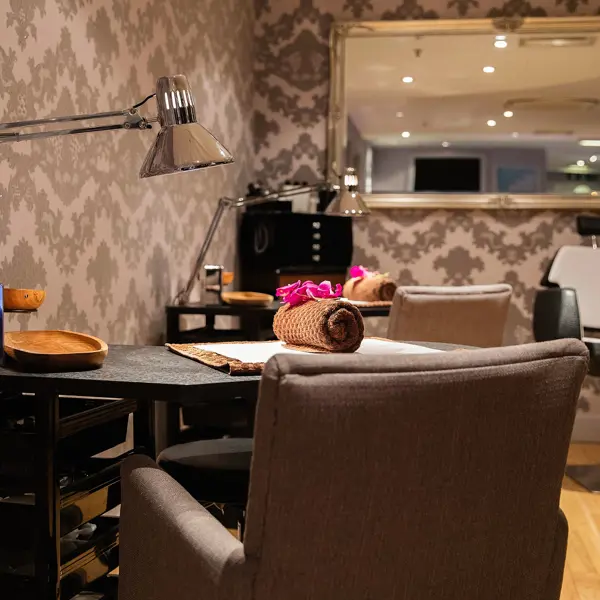 A well-furnished room featuring a desk, chair, and mirror.