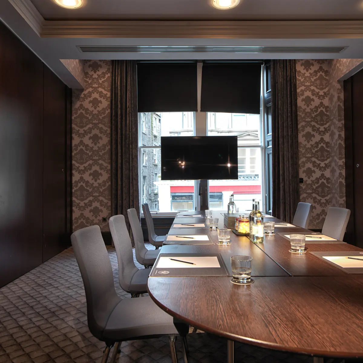 Conference room featuring a spacious table and chairs.